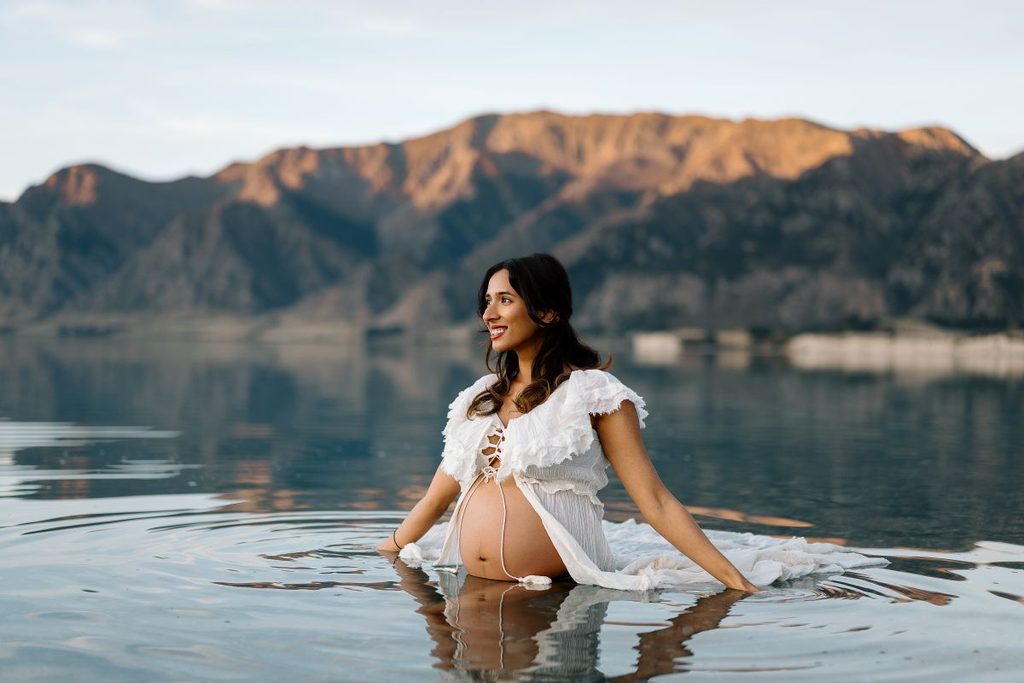 pregnant woman in the water for her maternity shoot at Lake Hawea, New Zealand.