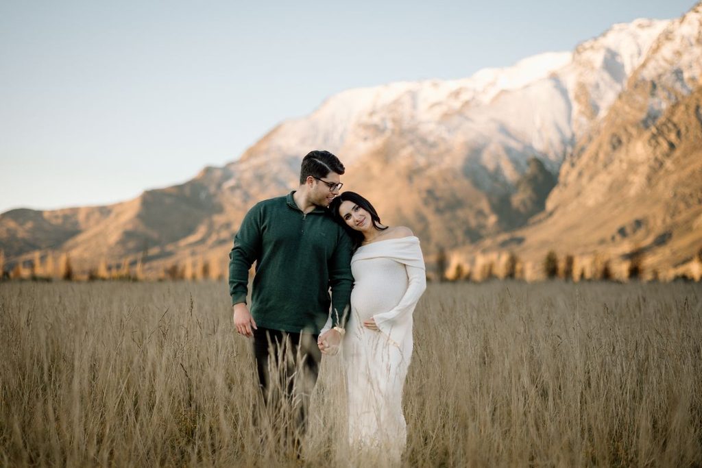 Couple at Jacks Point in Queenstown with the Remarkables in the background during their maternity photoshoot.