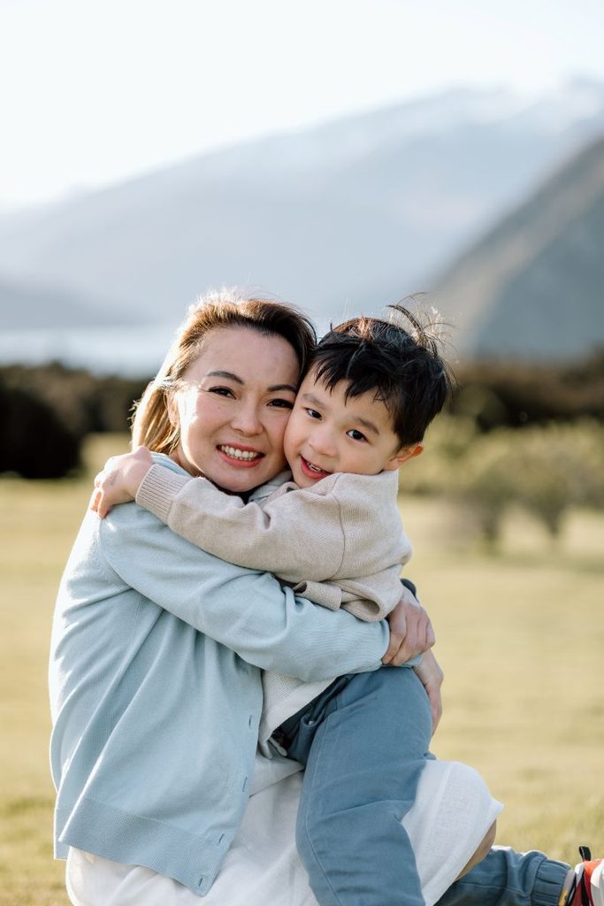 Singapore mum and little boy cuddled up during their photoshoot in Wanaka, New Zealand while on holidays.
