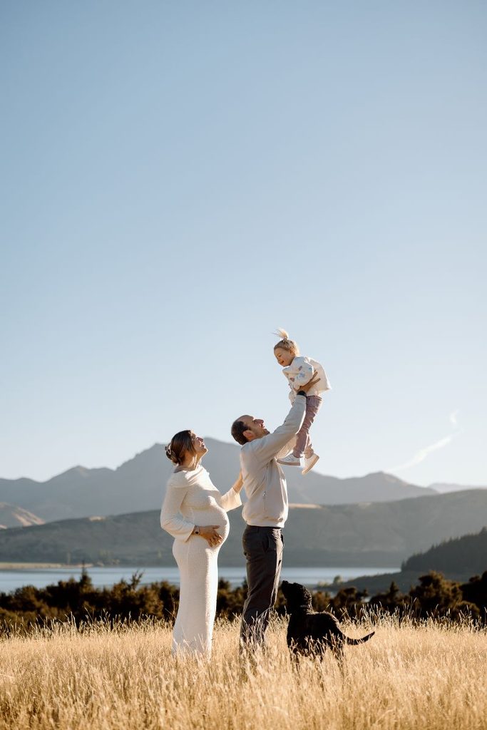 Family having fun during their maternity shoot at Jason's Clearing in Wanaka, New Zealand.