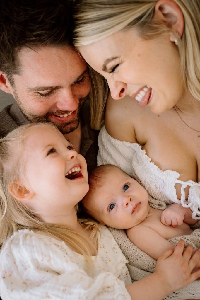 Queenstown family laughing during newborn photoshoot in Queenstown