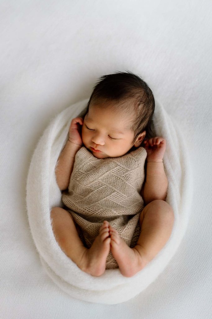 newborn wrapped up during photoshoot by Captured by Bie in Wanaka.